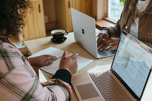 two women sitting opposite each other at a desk